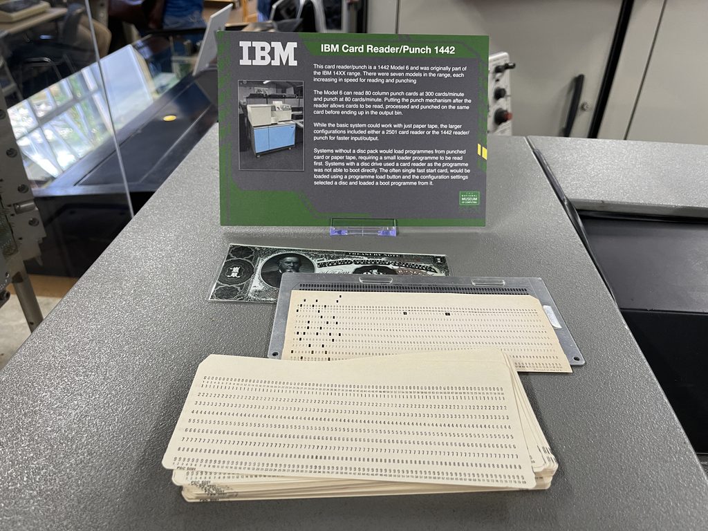 An IBM card reader and punch with punched cards on display